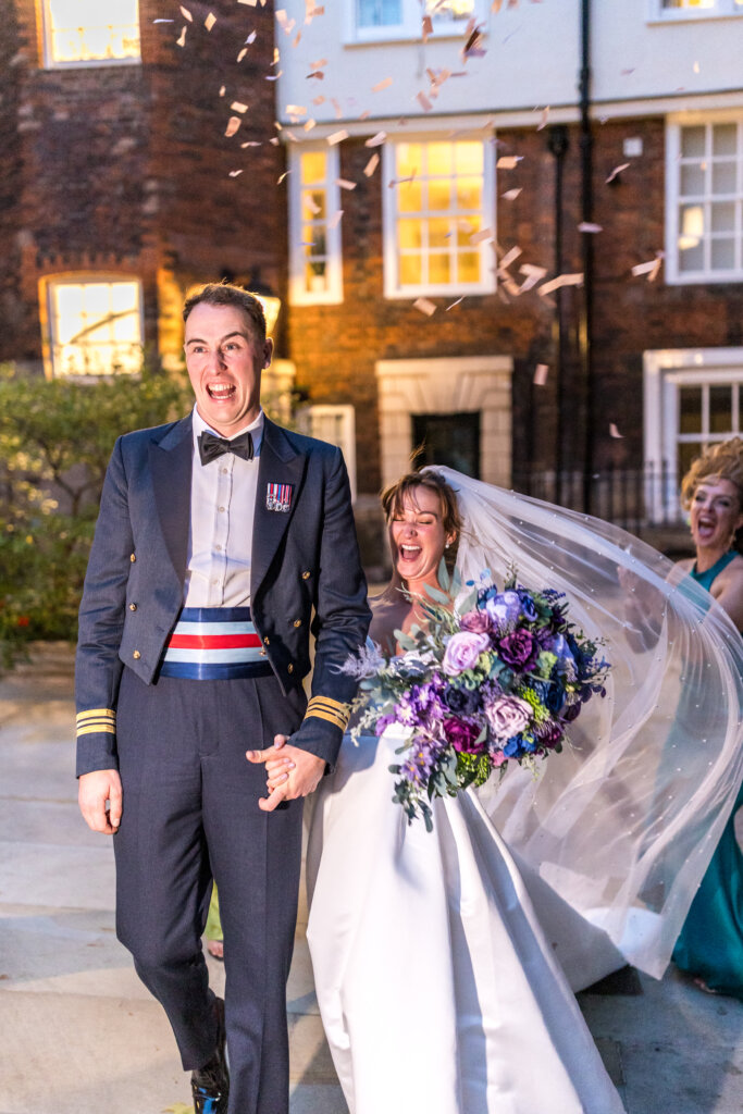 Surprise confetti gun makes the wedding couple laugh