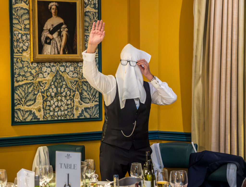 Groom face covering with a napkin.