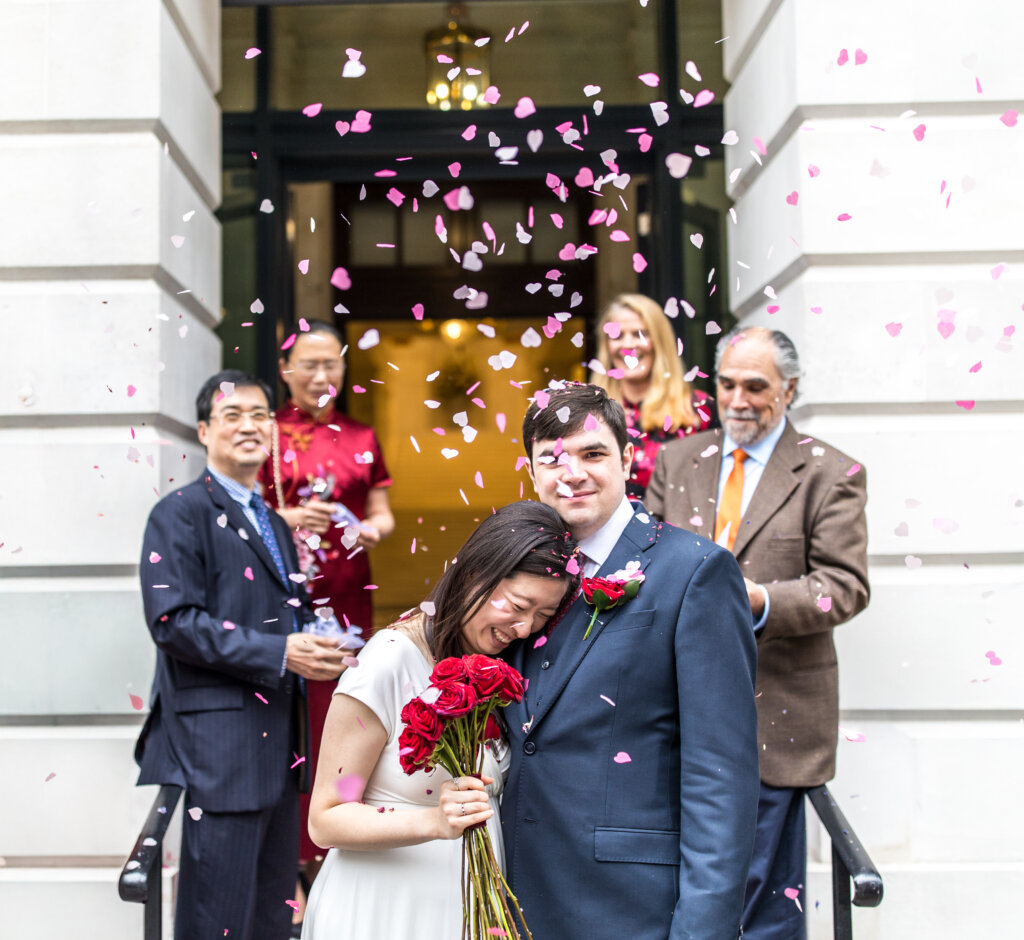 Happy confetti picture, wedding guests and Bride & Groom.