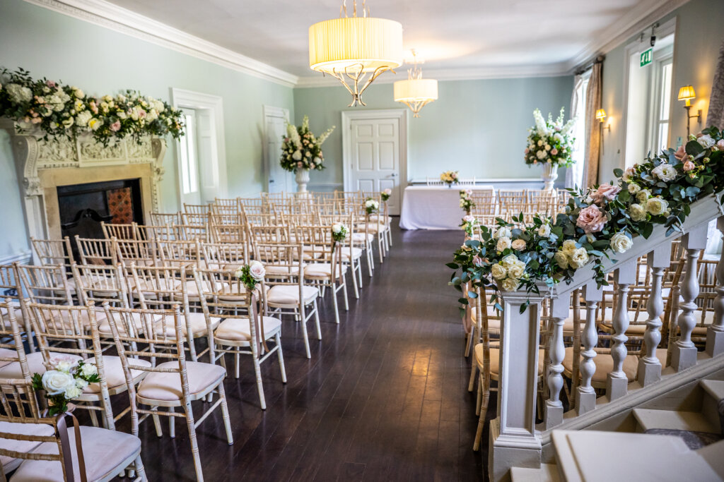 Willow Room at Morden Hall set up empty for a civil wedding ceremony with floral decorations